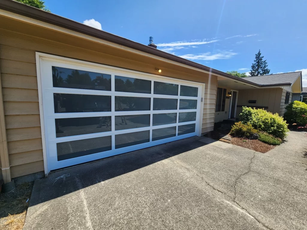 Modern glass garage door with grid design on driveway