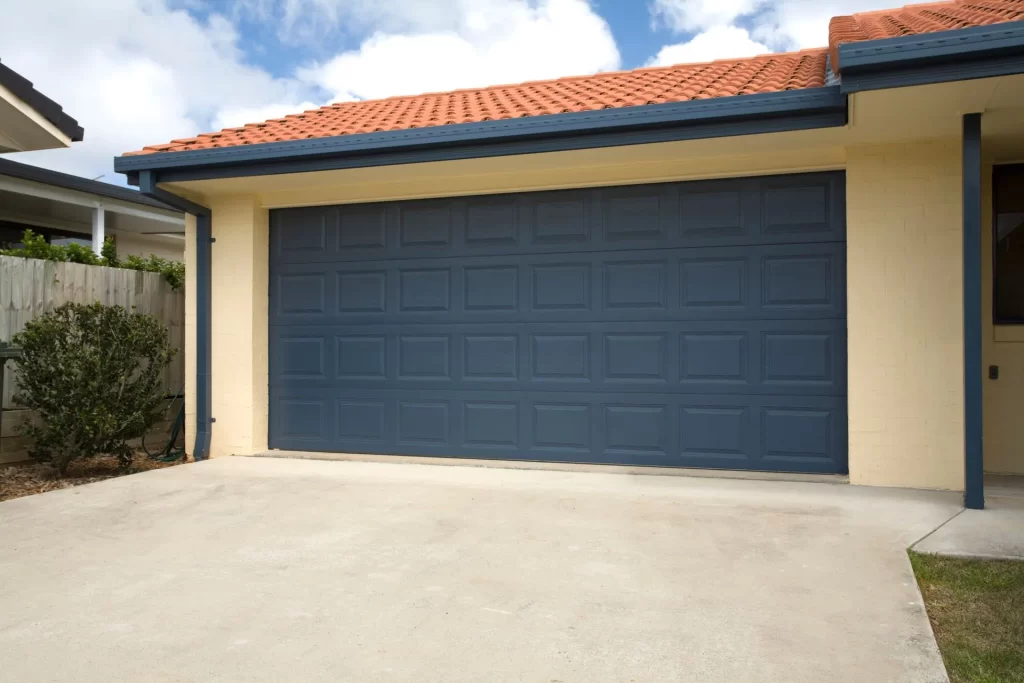 Double car modern garage door with horizontal panels and beige exterior