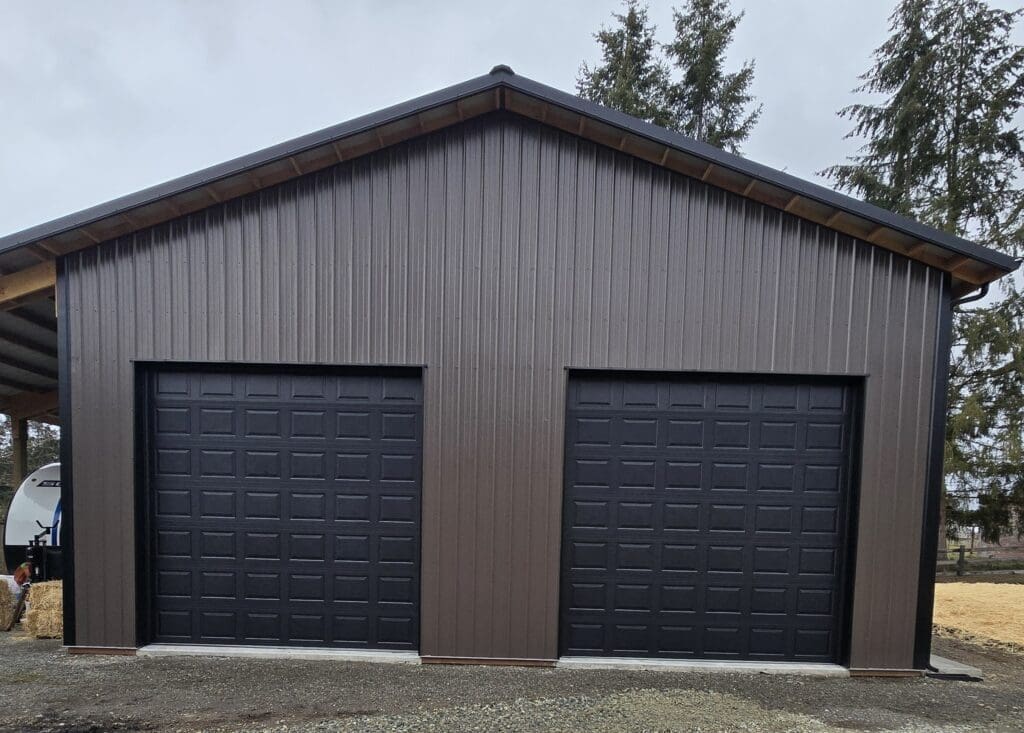 Two black garage doors on building