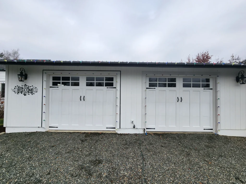 White garage doors with holiday lights